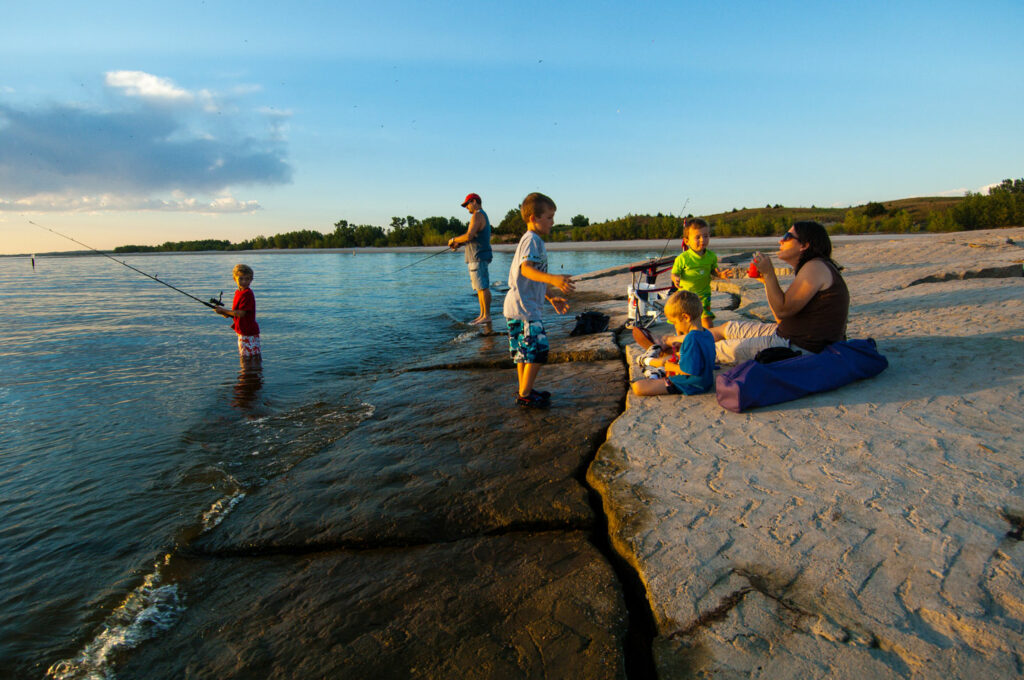 A family fishes from the beach