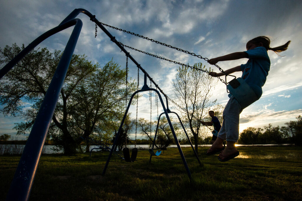 A boy and girl swing