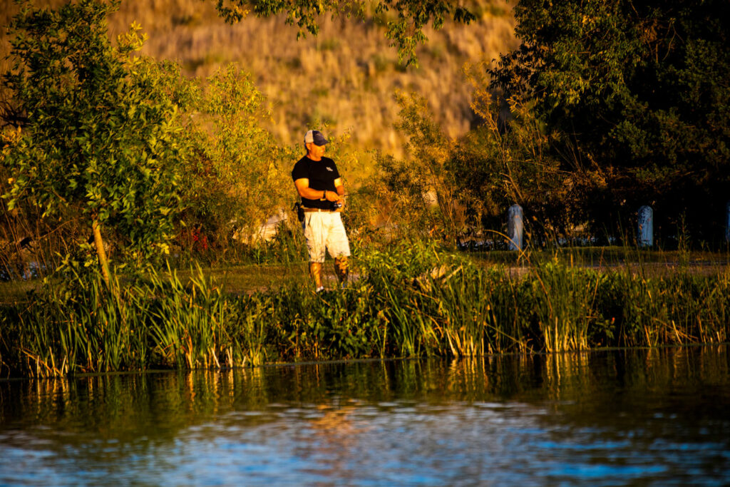 A man fishes from shore