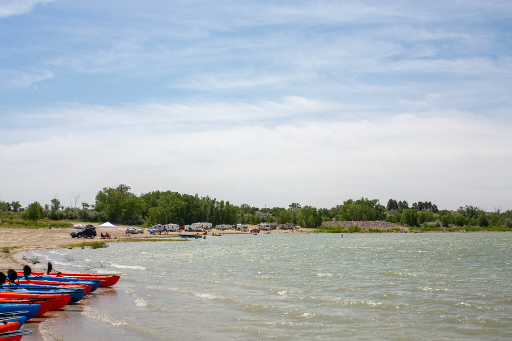 Kayaks and campers at the edge of a lake