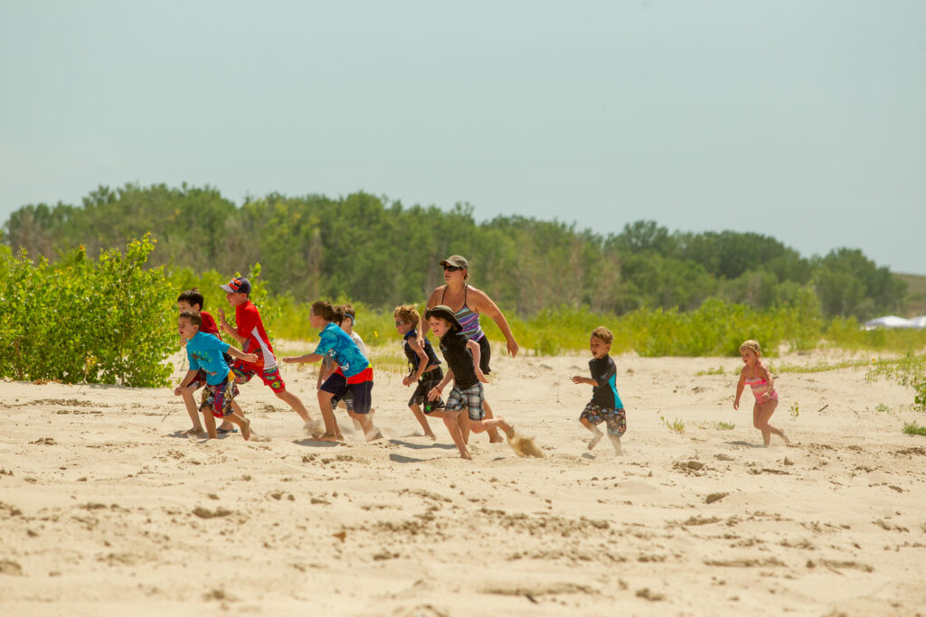 People run across the beach