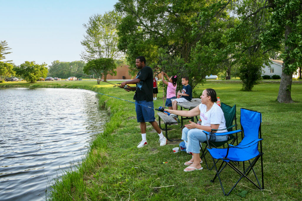 a family fishes from the bank of the lake