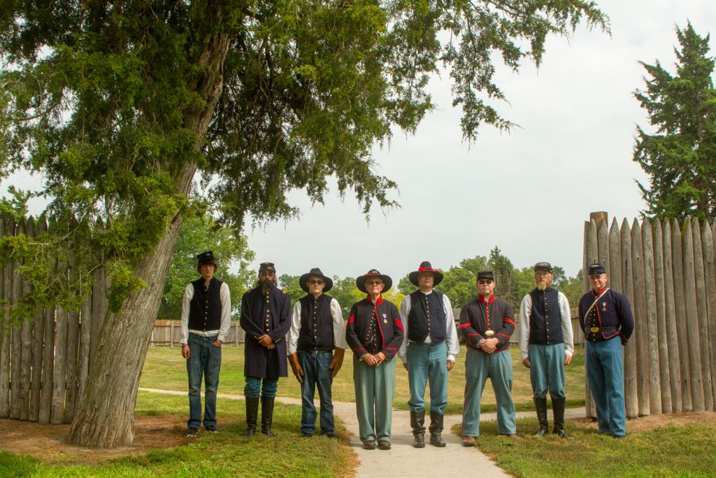 Men in period costumes pose