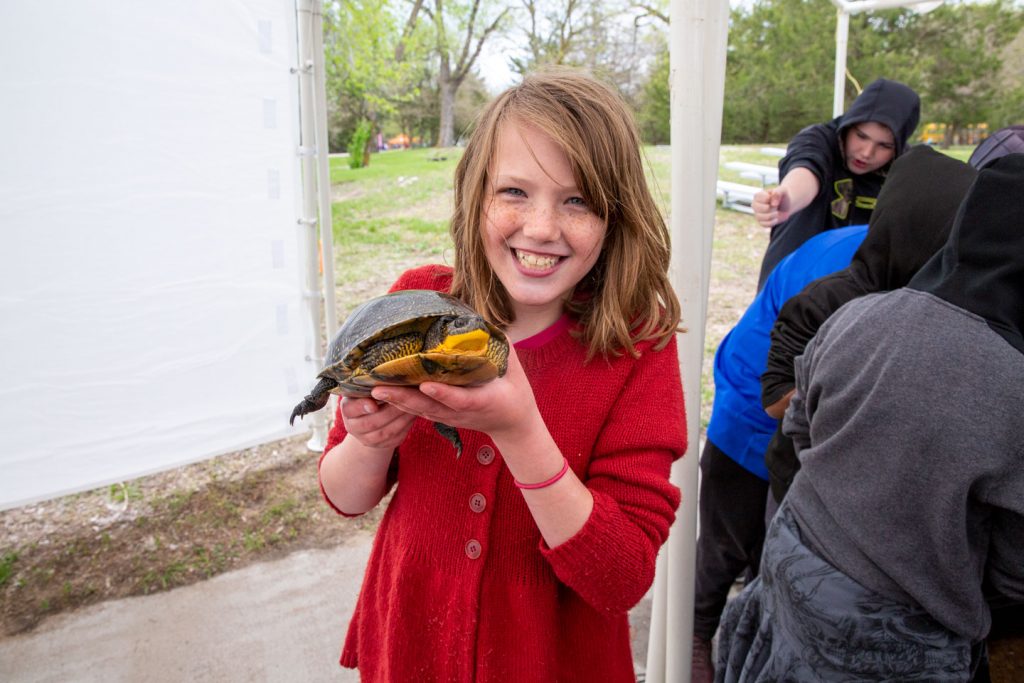 A girls holds a turtle