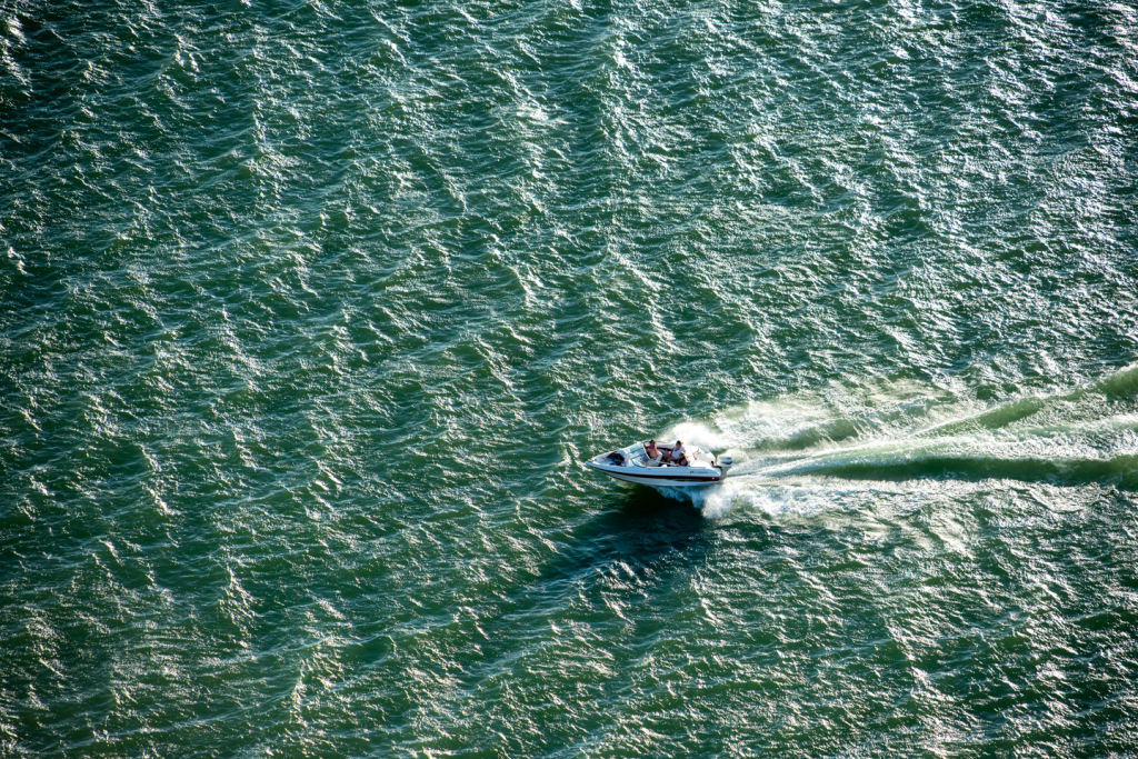 A powerboat speeds across the lake