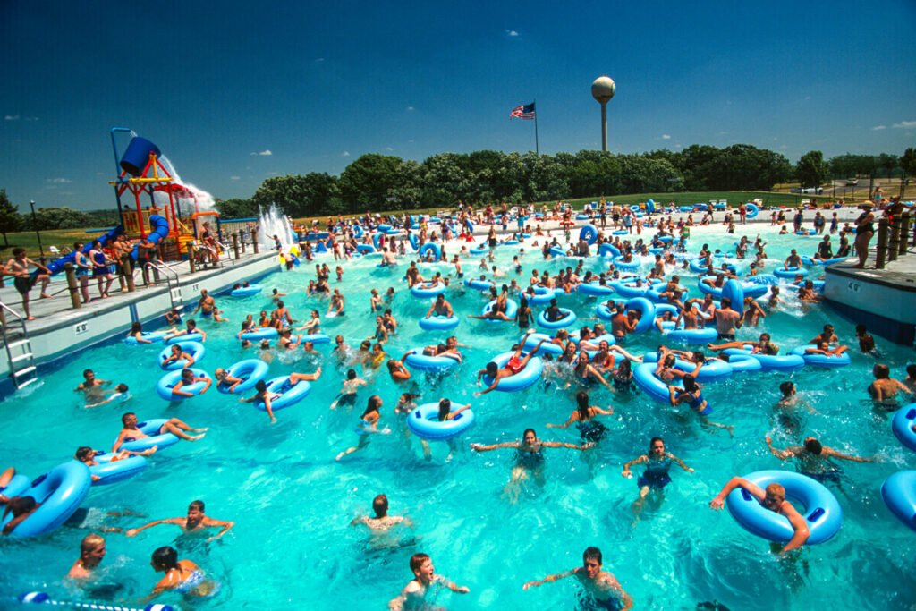 The wave pool at the Eugene T. Mahoney State Park Family Aquatic Center, full of people on their tubes riding the waves.