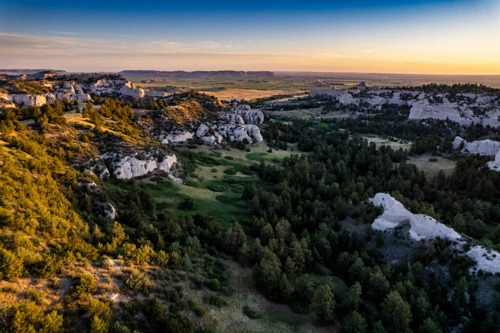 A drone view of Wildcat Hills bluffs and pine trees