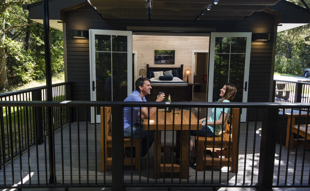 glamping cabins include a large deck with a table and chairs