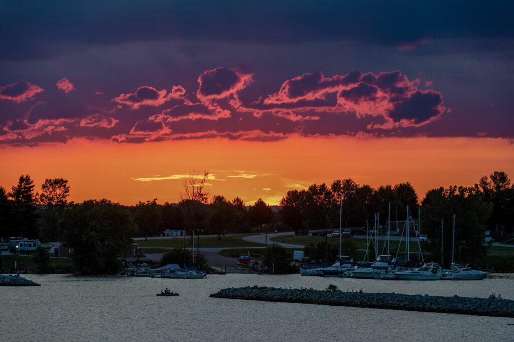 Sunset scene of a kayaker fishing near a marina at Branched Oak Lake.