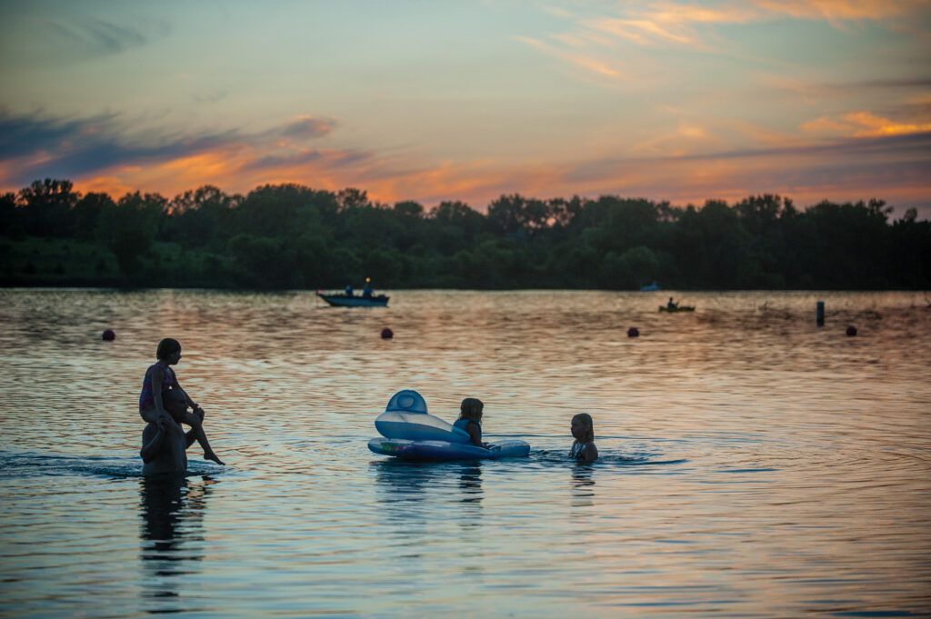 People play in the water at Wagon Train lake.