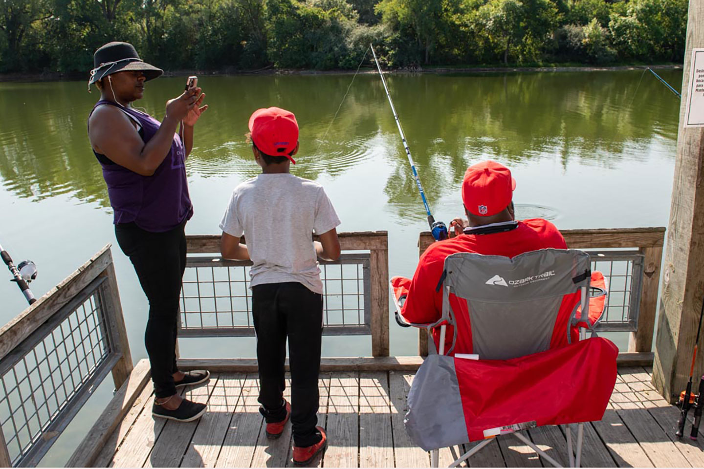 three people fish on an accessible fishing pier in Nebraska