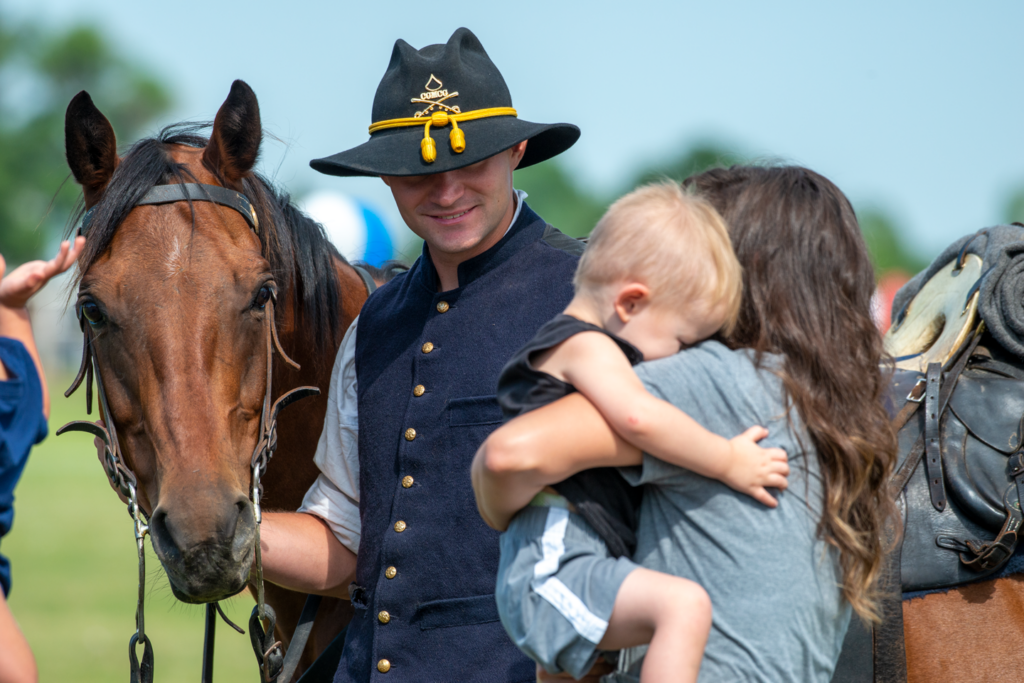 A reenactment soldier says hello to a toddler