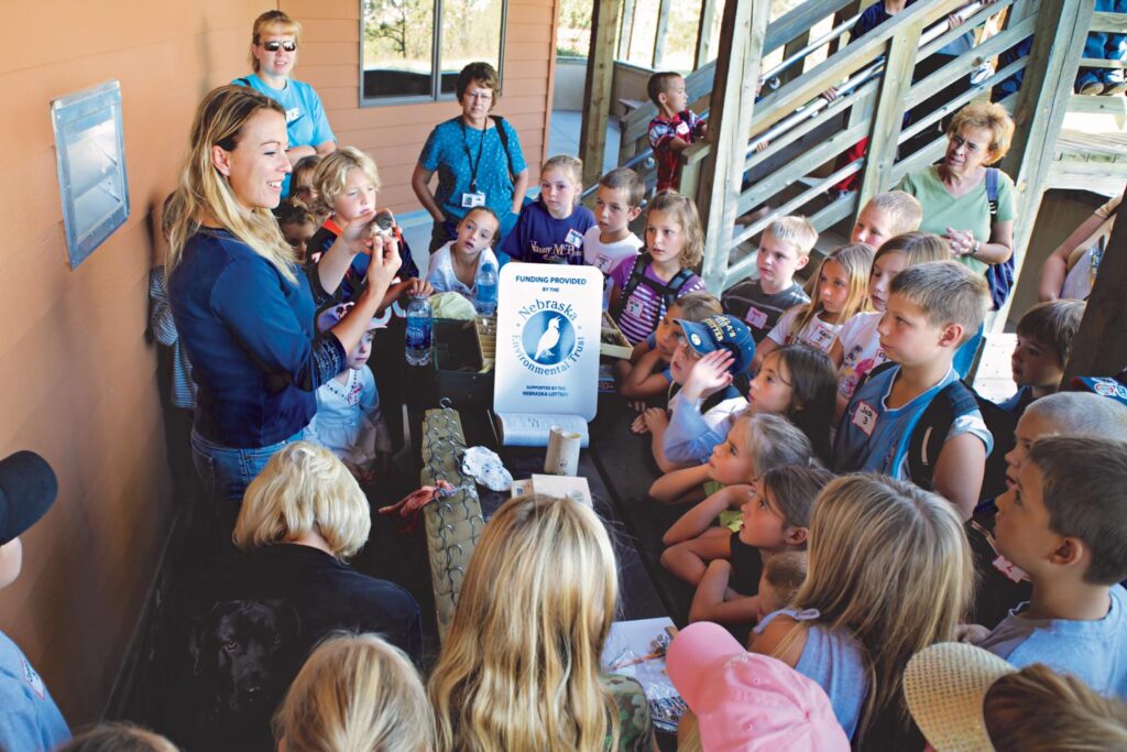 An educator holds a bird in her hand