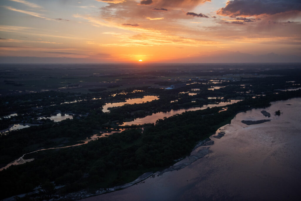 An aerial photo shows the sunrise over the Platte River and sandpit lakes over Fremont SRA.