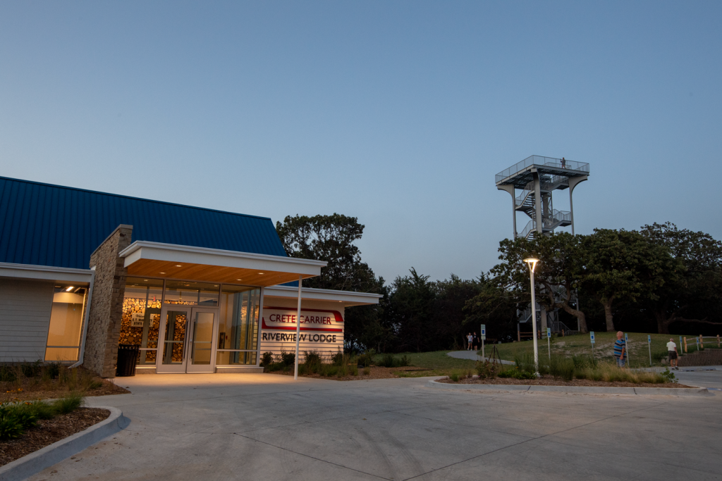 The lodge at night next to an observation tower