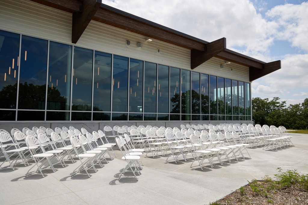 Rows of white chairs in front of the lodge