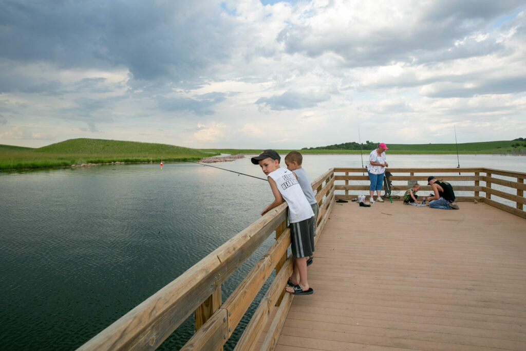 Two boys fish from a dock