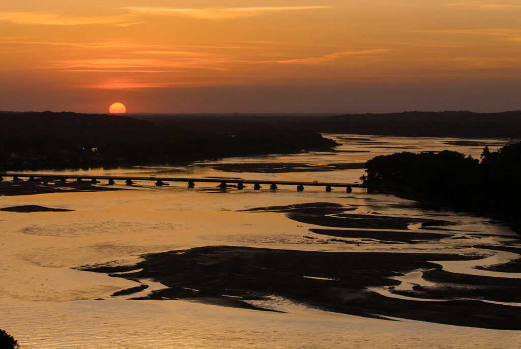 Sunset view over the Platte River of the Lied Platte River Bridge.